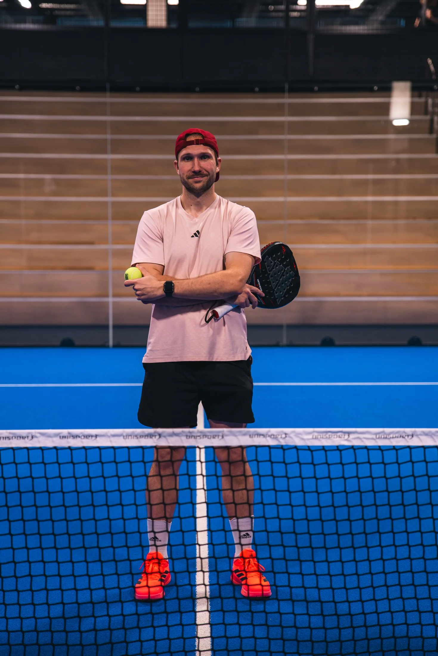 Nikita on a padel court with his racket