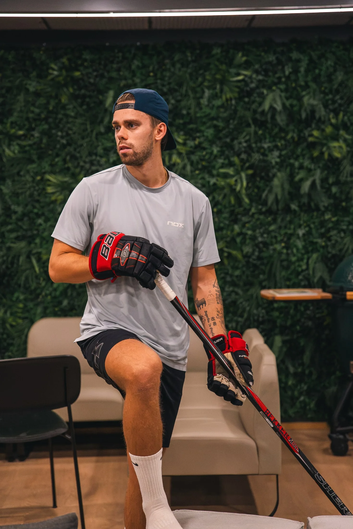 Mikael with an ice hockey stick and gloves