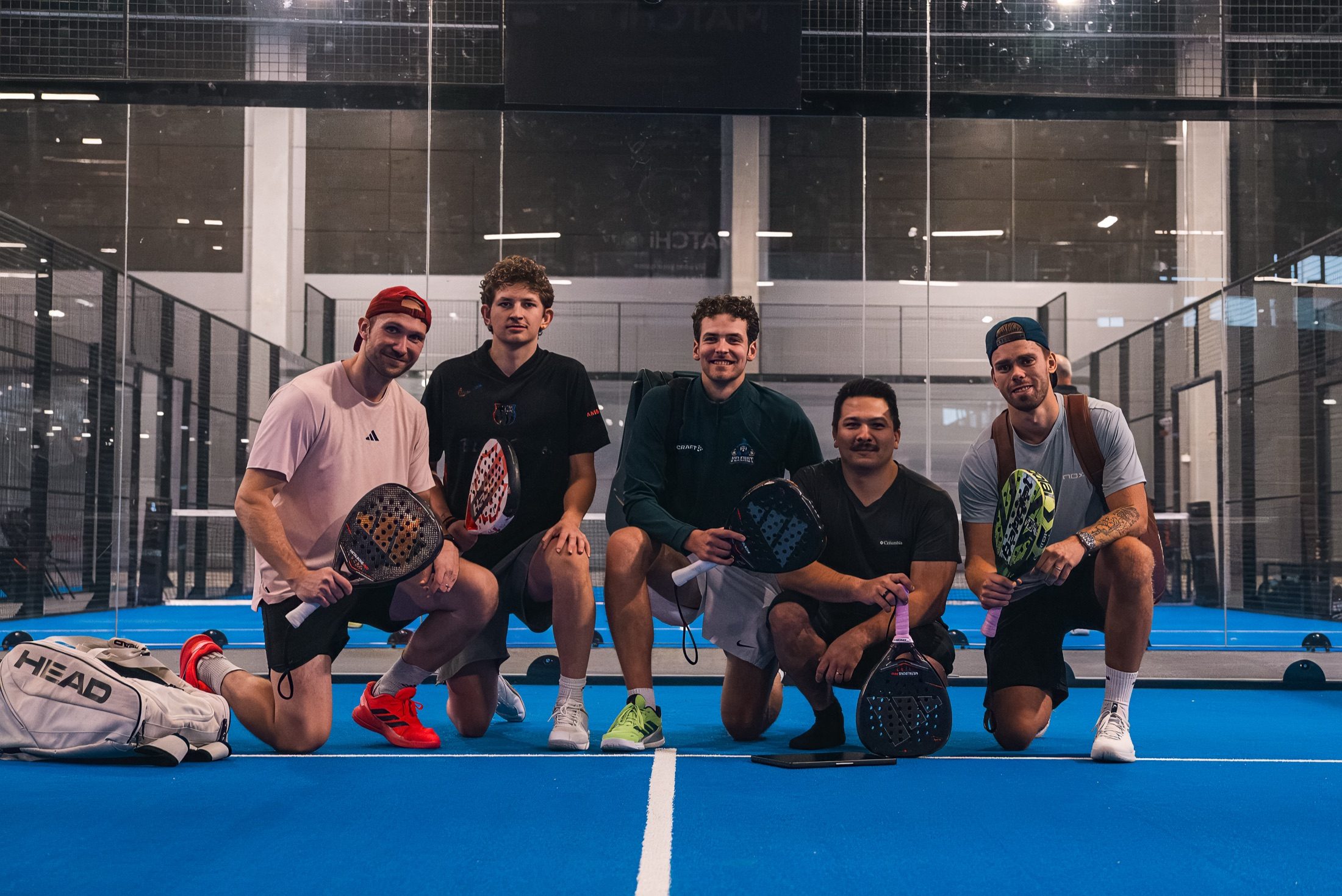 The Innovila team on a padel court, rackets in hand