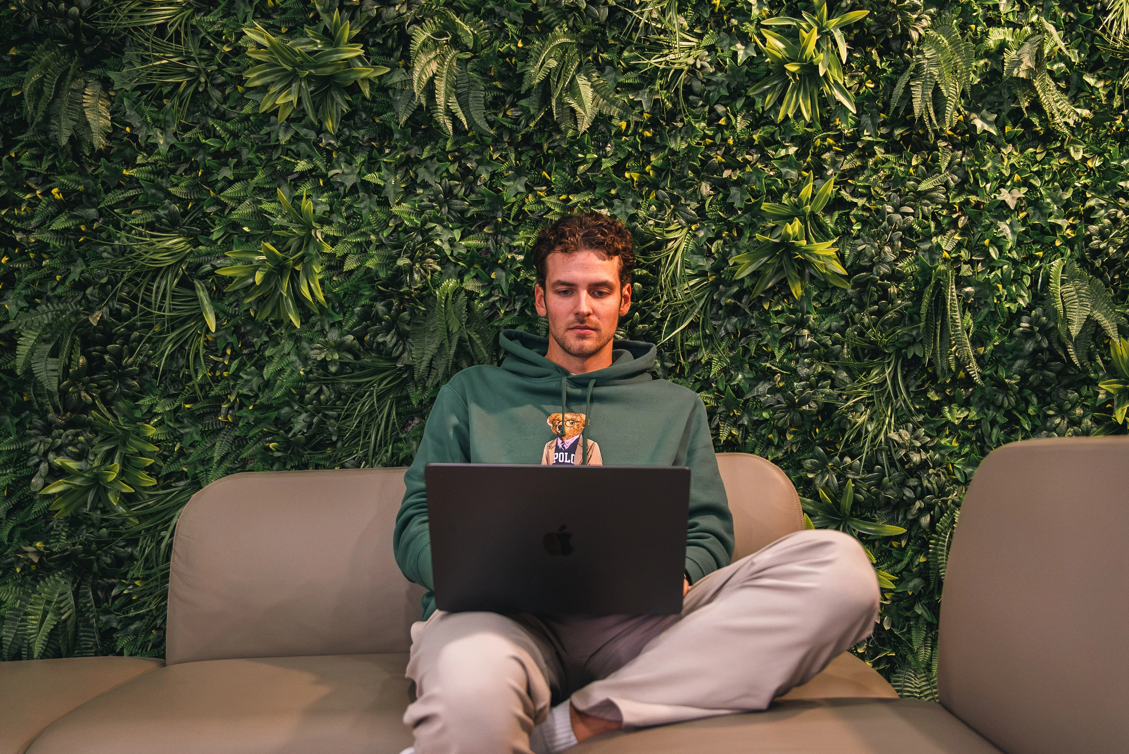 A member of the Innovila team working on a laptop on a sofa