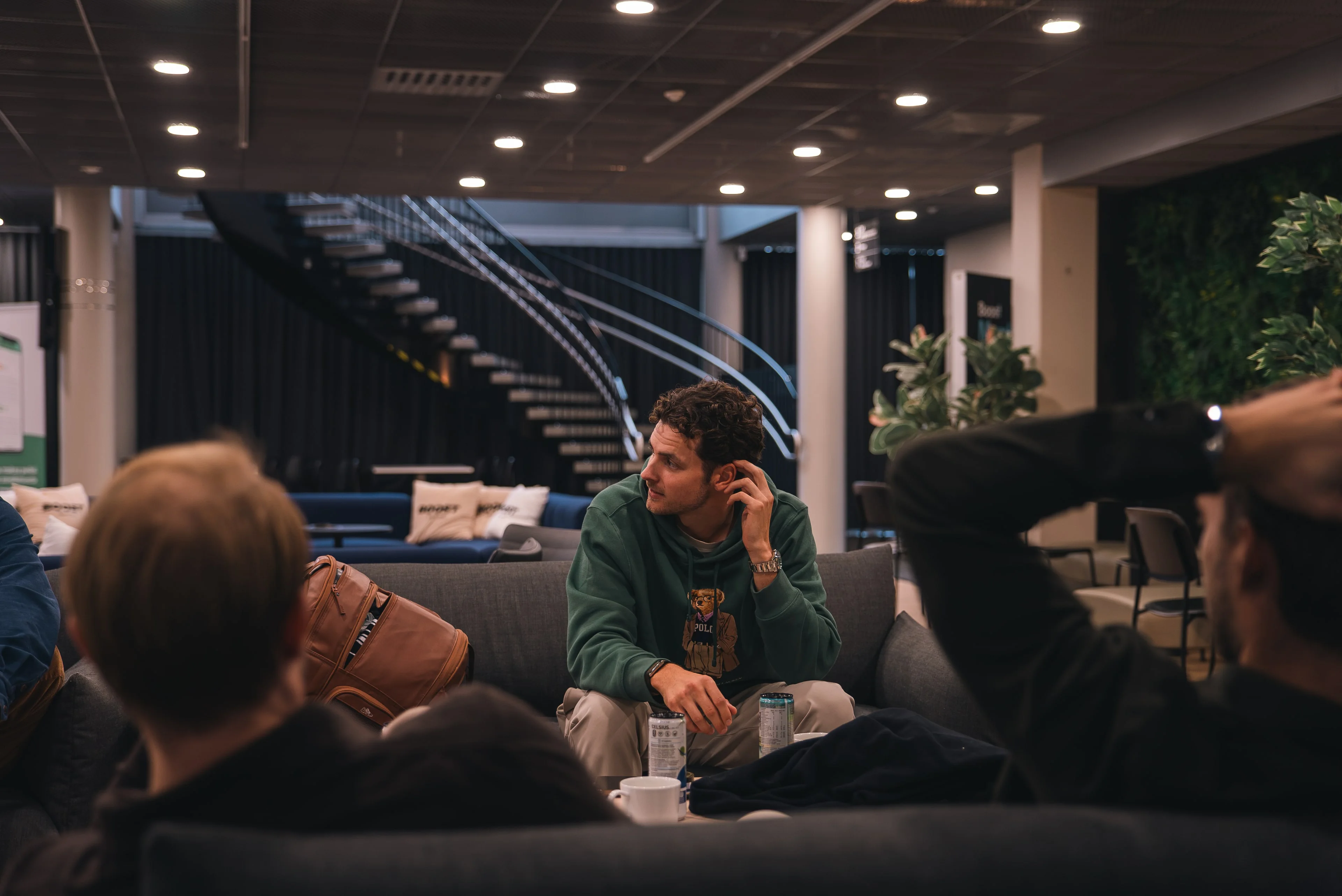 A member of the Innovila team talking with colleagues in the office lounge