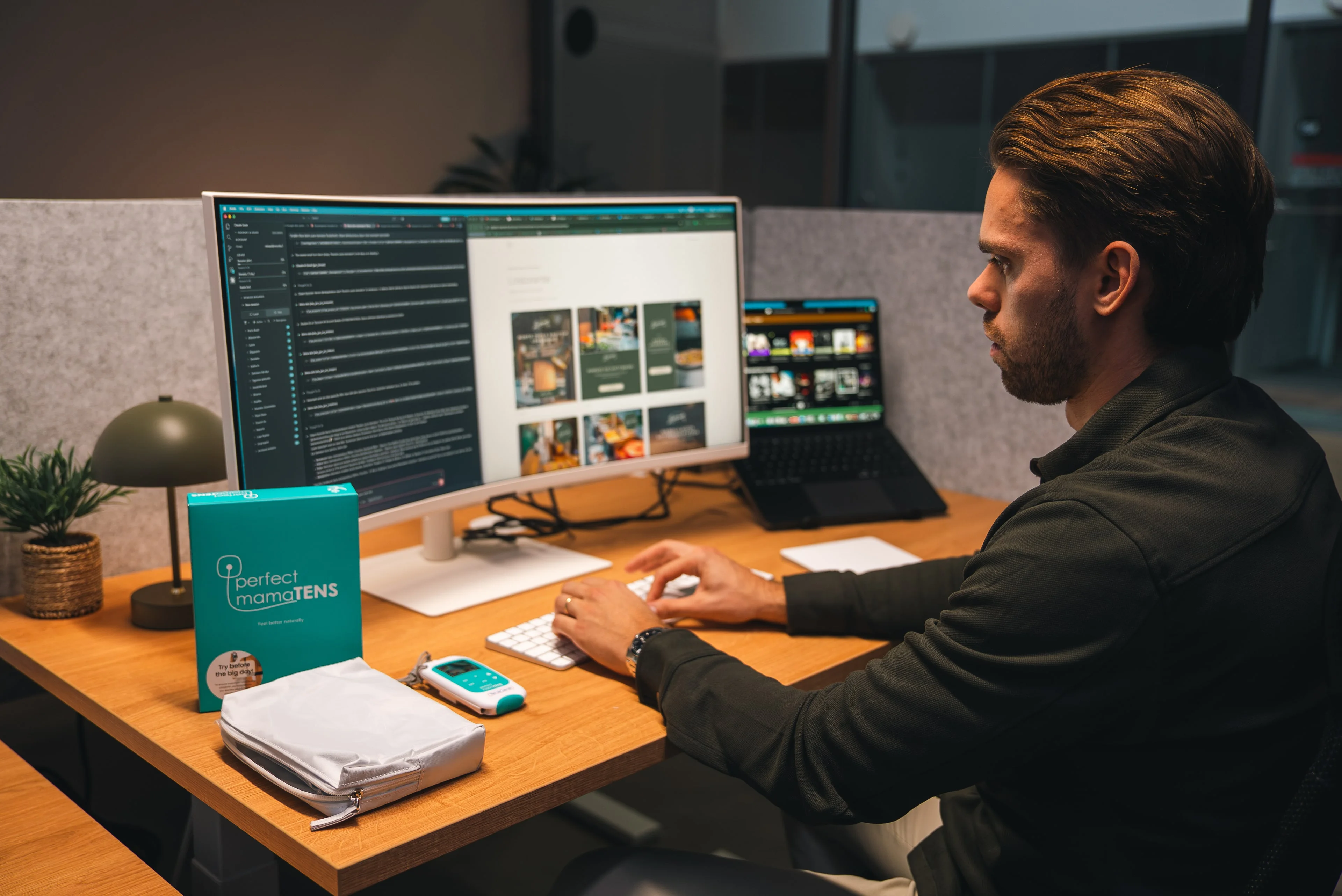 A member of the Innovila team working at a desk with a large screen