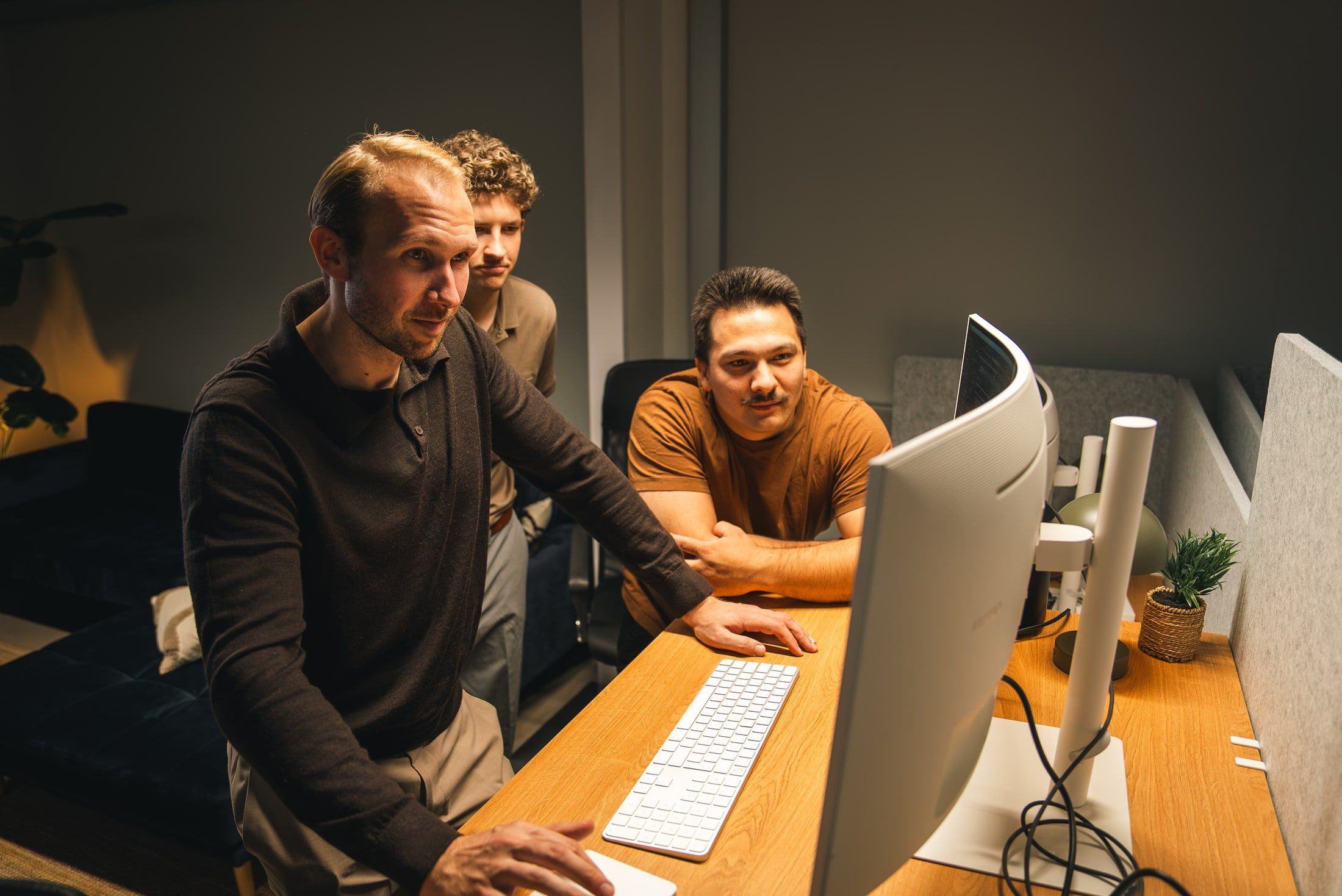 Members of the Innovila team working together at a computer